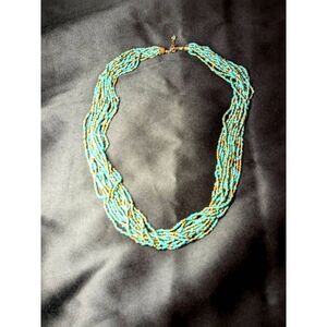 Thick 12 strand seed bead necklace with brass accents. 26 inches long
